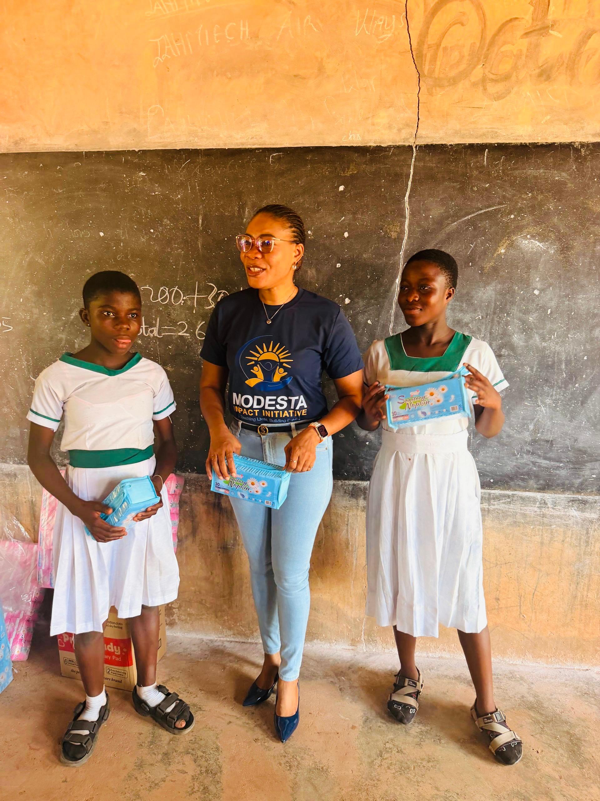 School girls receiving sanitary pads at a menstrual hygiene outreach